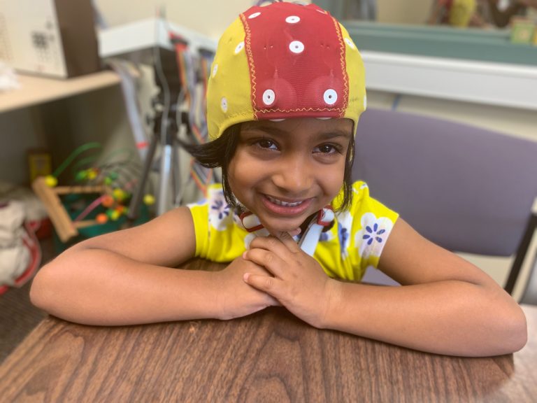 Young girl smiling wearing the cap