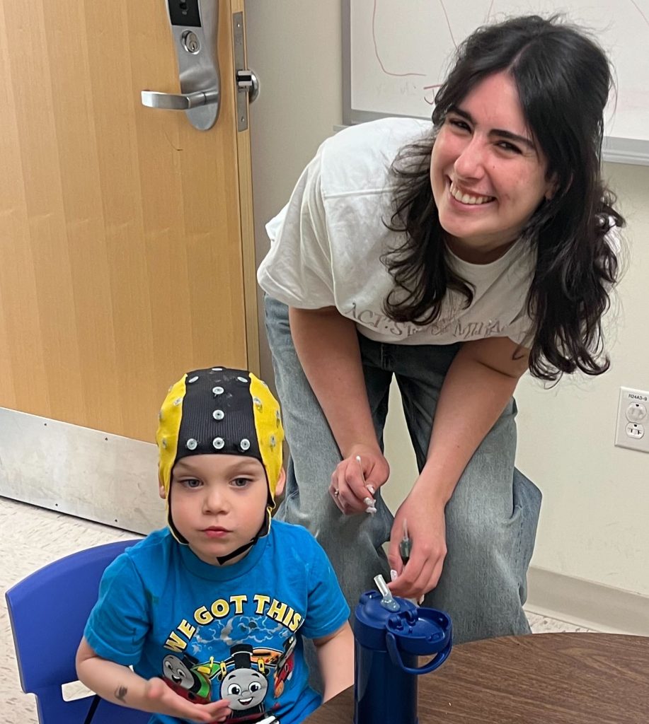 Liv in the act of capping a child for research.
